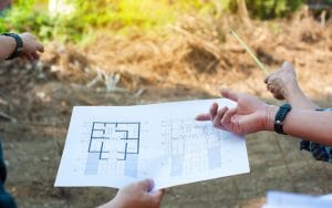 A paper with a building plan drawn on agricultural land