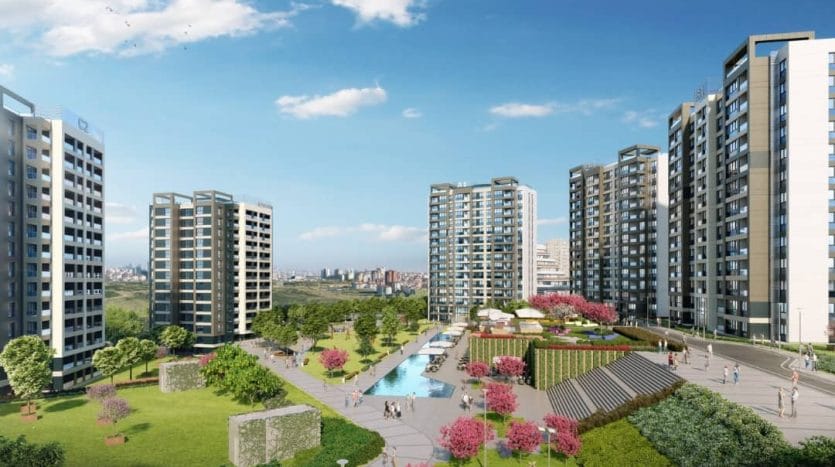 مباني سكنية ضمن مجمع سكني كبير يفصل بينها أشجار وطرقات فرعية ومسطح مائي