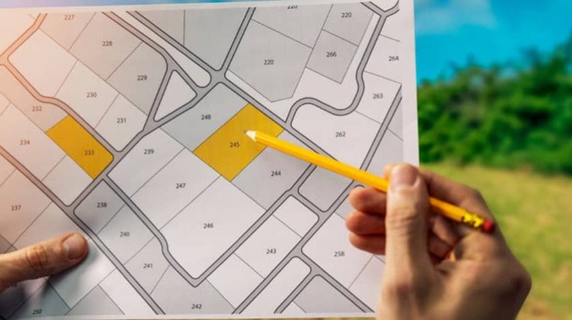 A diagram on a white sheet of squares representing plots of land for investment