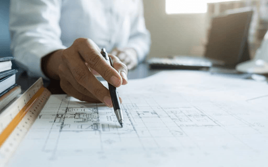 Investment project plan on a white sheet of paper on a desktop